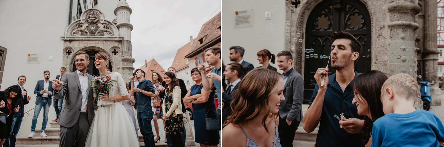 wedding guests blowing bubbles outside church at boho wedding in germany