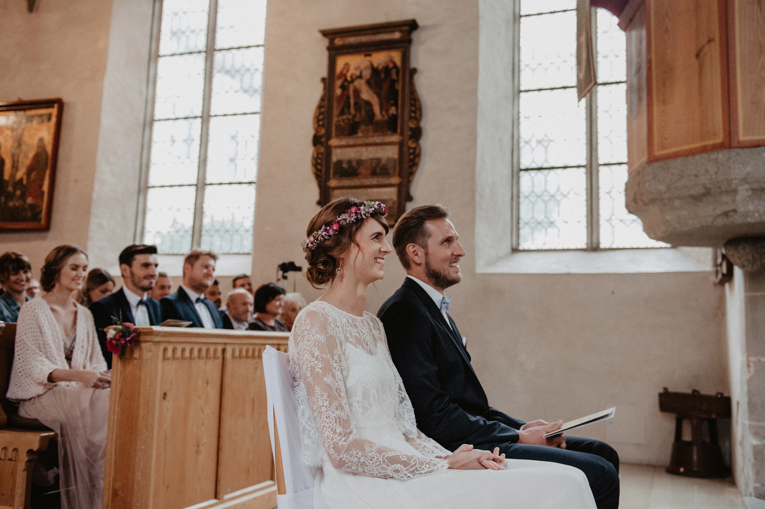bride and groom listening to vicar during boho folk rustic inspired ceremony