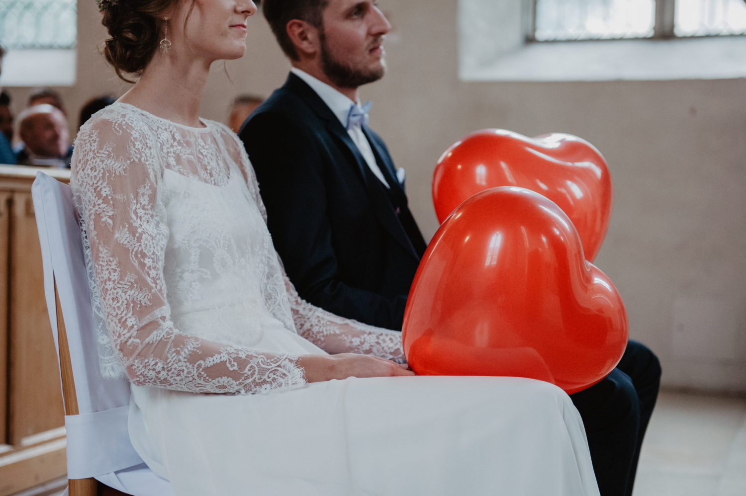 red heart shaped balloons at boho wedding