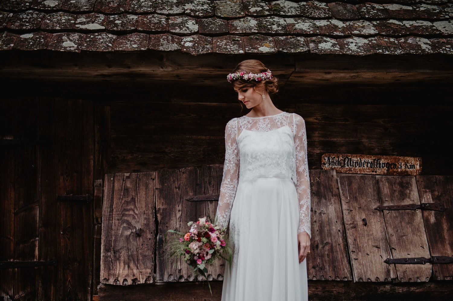 boho bride holding wild meadow flowers dark red bouquet