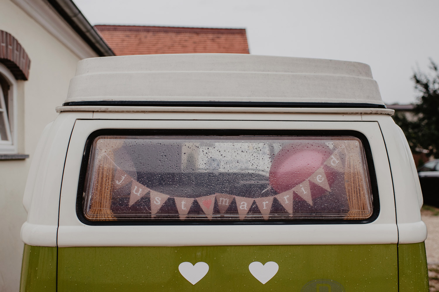 vintage VW van with just married sign in the rain